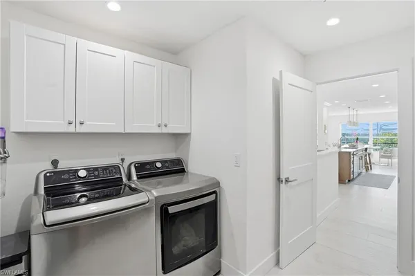a kitchen with a stove and white cabinets