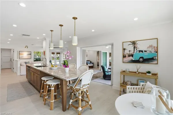 a dining room with furniture and a floor to ceiling window
