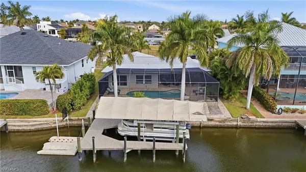 an aerial view of residential houses with outdoor space and ocean view