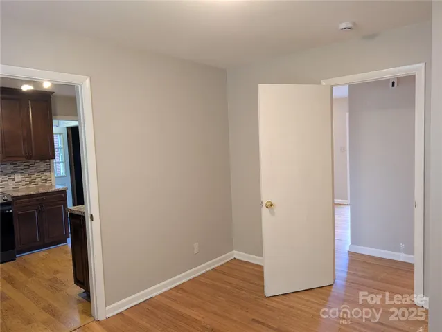 a view of hallway with wooden floor