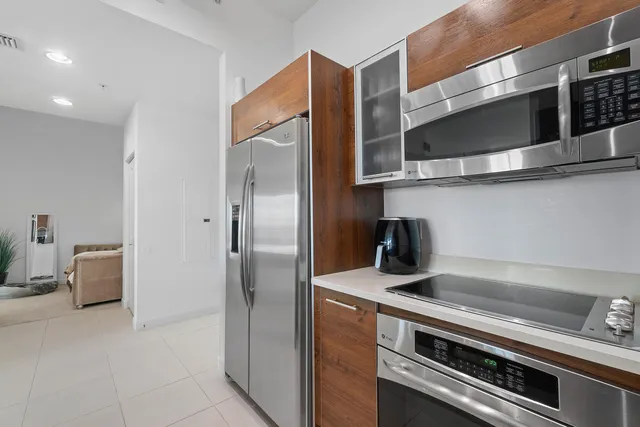 a kitchen with stainless steel appliances granite countertop a refrigerator and a stove