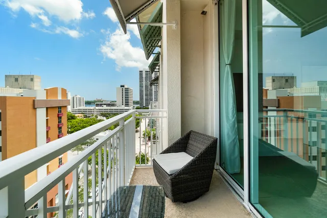 a view of a balcony with couches and city view