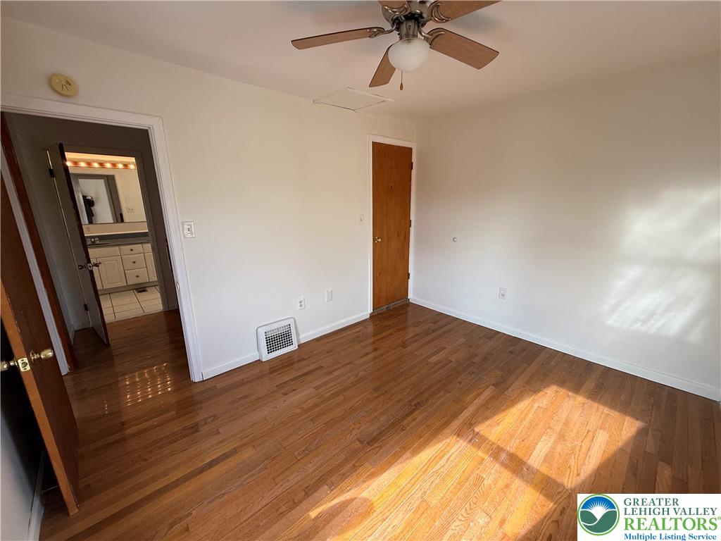 2955 Middletown Road Bethlehem, PA 18020 - Photo 15 of 20 Warm hardwood flooring and a ceiling fan create a comfortable atmosphere.