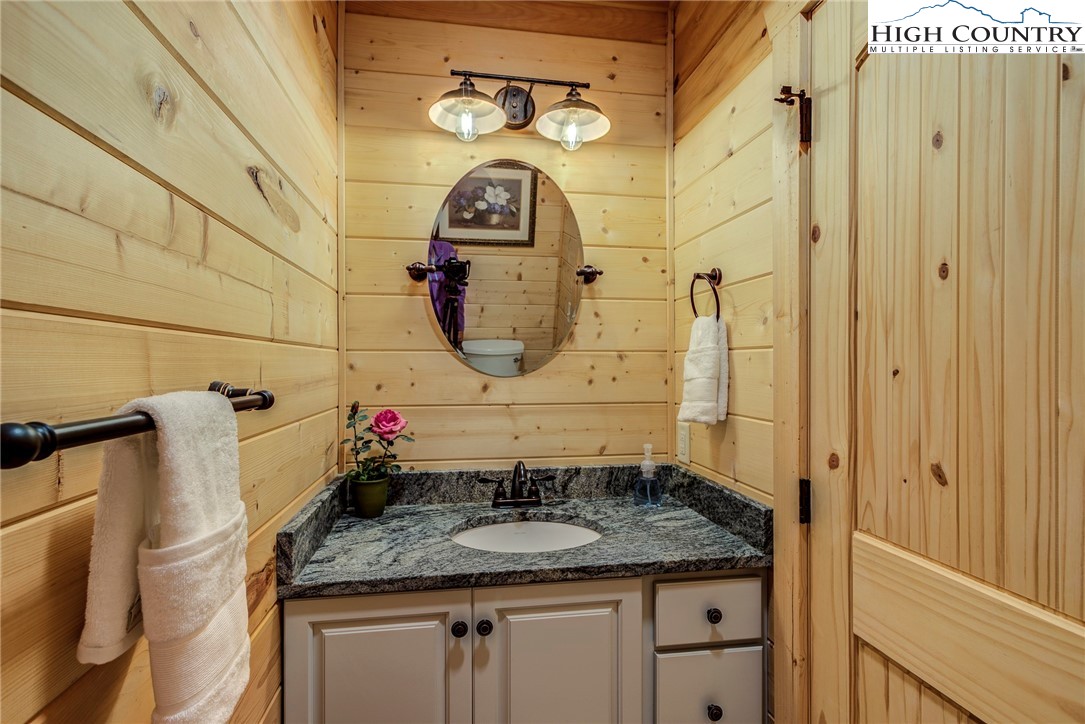 3460 South Center Church Road Thurmond, NC 28683 - Photo 33 of 50 a bathroom with a granite countertop sink and a mirror