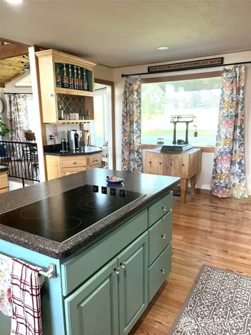 a kitchen with stainless steel appliances a sink and large window
