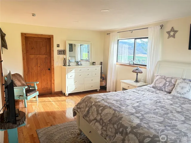 a bedroom with a large bed and a dresser