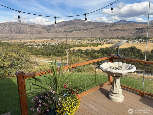 a view of a chairs and table in the balcony