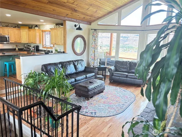 a living room with furniture and a floor to ceiling window