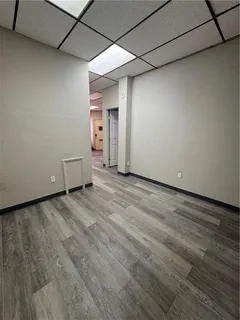 a view of room with wooden floor and window