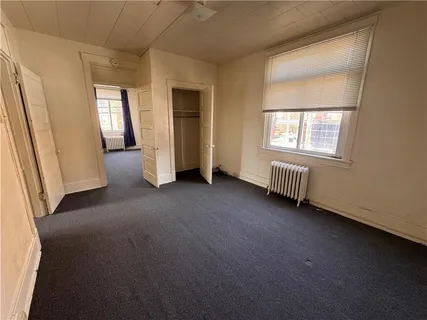 a bedroom with a bed and a mirror