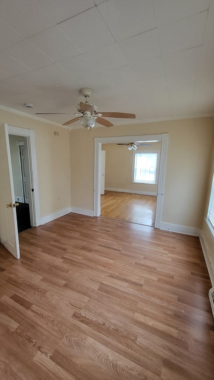 238 Hildreth Street, Unit 238 Lowell, MA 01850 - Photo 11 of 16 wooden floor in an empty room with a window