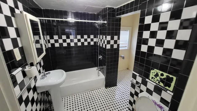 a bathroom with a sink toilet and shower