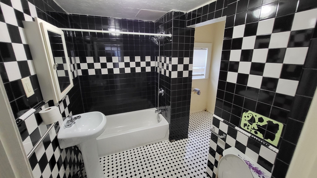 238 Hildreth Street, Unit 238 Lowell, MA 01850 - Photo 6 of 16 a bathroom with a sink toilet and shower