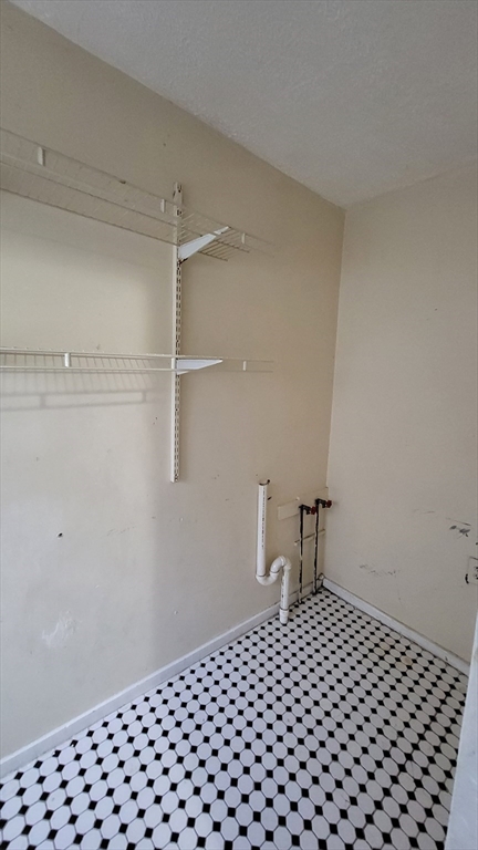 238 Hildreth Street, Unit 238 Lowell, MA 01850 - Photo 8 of 16 a bedroom with a bed and a table