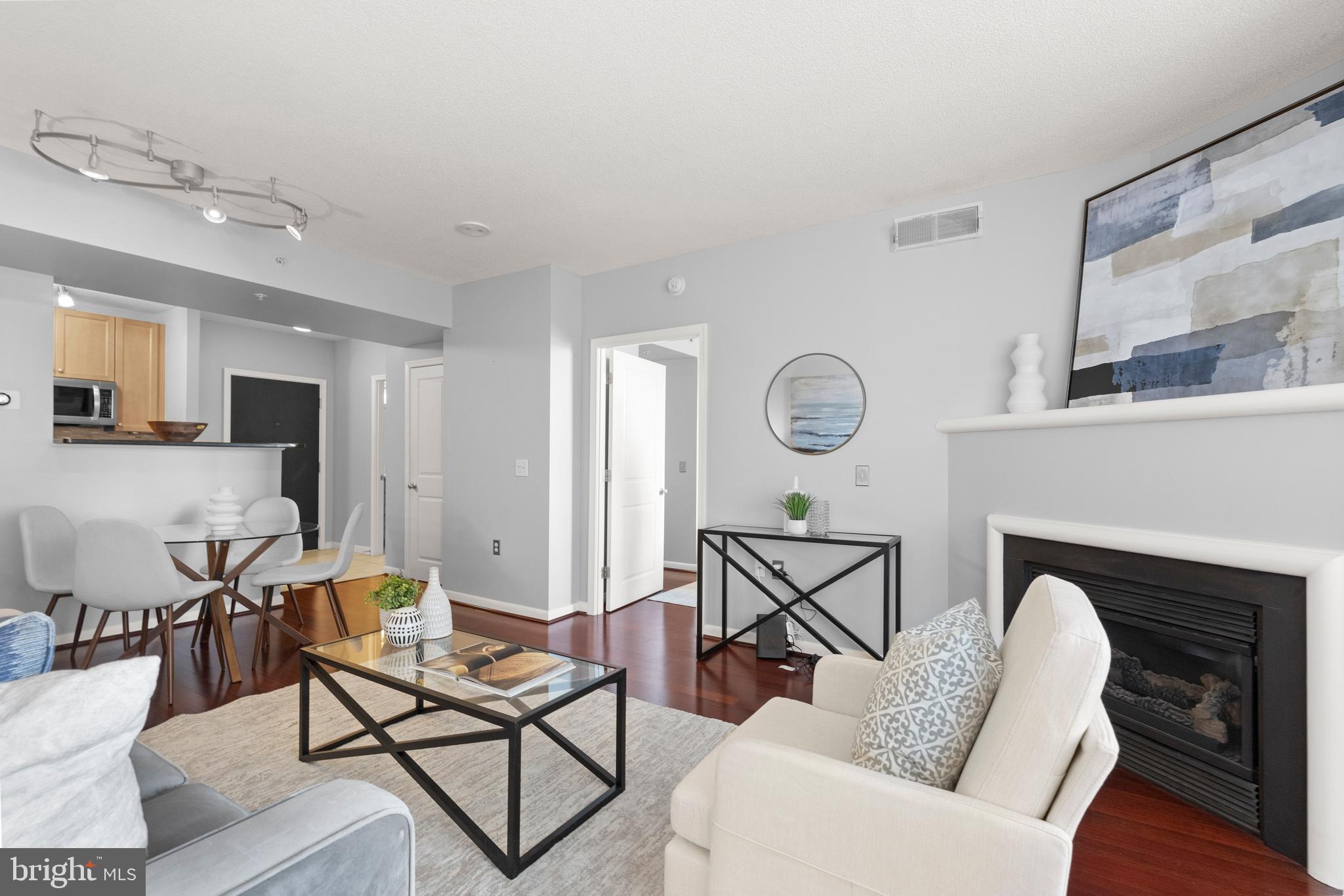 851 North Glebe Road, Unit 1508 Arlington, VA 22203 - Photo 13 of 41 a living room with furniture a fireplace and wooden floor