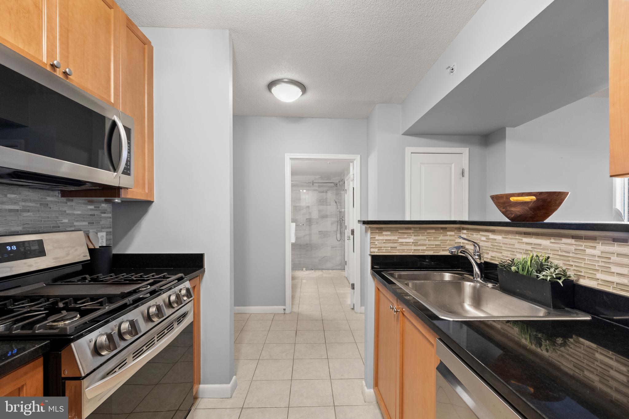 851 North Glebe Road, Unit 1508 Arlington, VA 22203 - Photo 8 of 41 a kitchen that has a sink and a stove