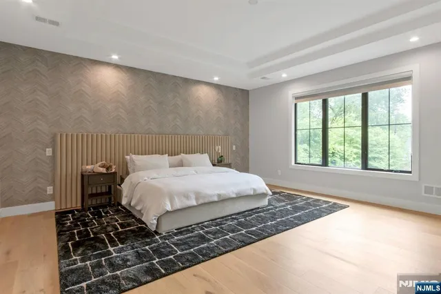 a large bed sitting in a room next to a window