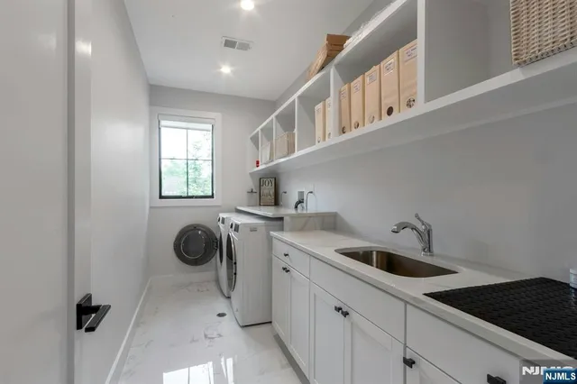 a kitchen that has a sink and cabinets
