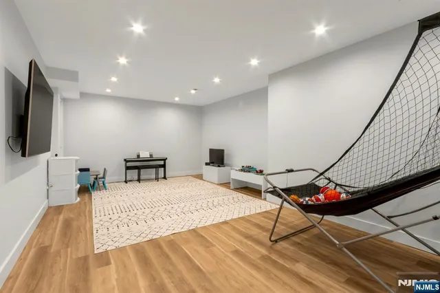 a large bedroom with a bed and a flat screen tv