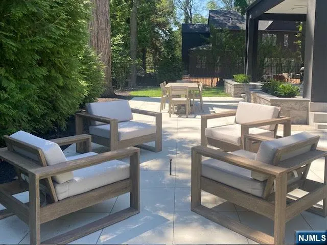 a view of backyard with seating area and green space