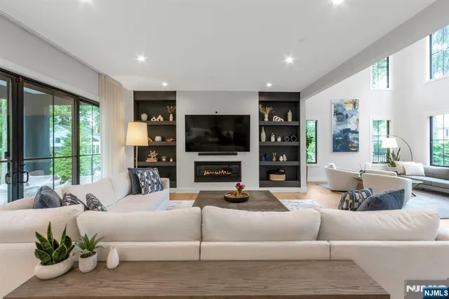 a living room with furniture tv and a fireplace