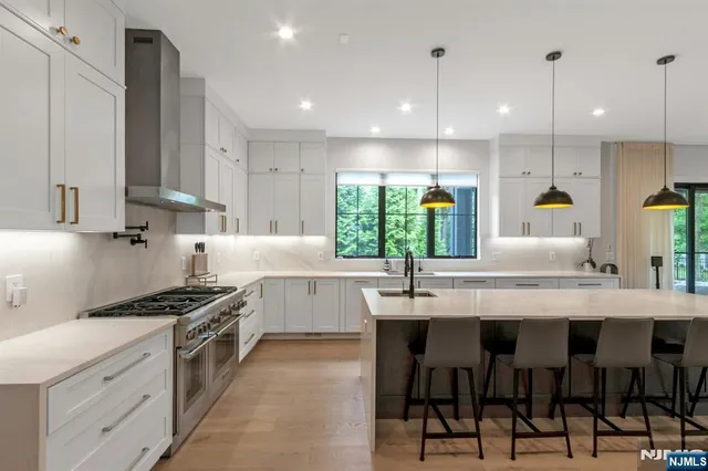 a kitchen with stainless steel appliances kitchen island granite countertop a sink and cabinets