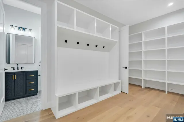 a view of an empty room with cabinet and stairs