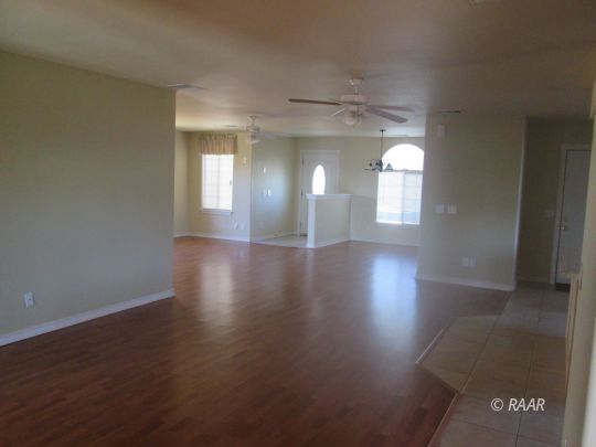 1240 South Farragut Street Ridgecrest, CA 93555 - Photo 4 of 14 an empty room with wooden floor and a window