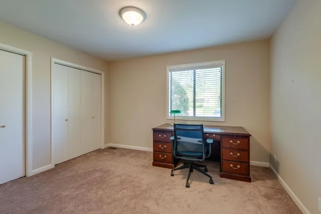 a kitchen with granite countertop white cabinets and a stove top oven