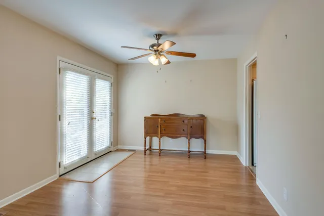 a view of a livingroom with wooden floor and a couch