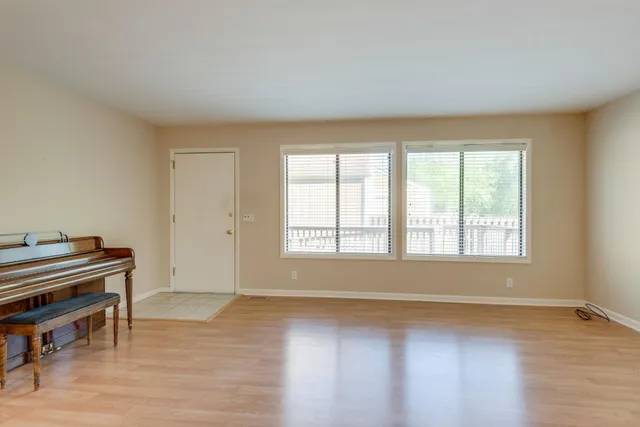 a view of a livingroom with furniture wooden floor and a window