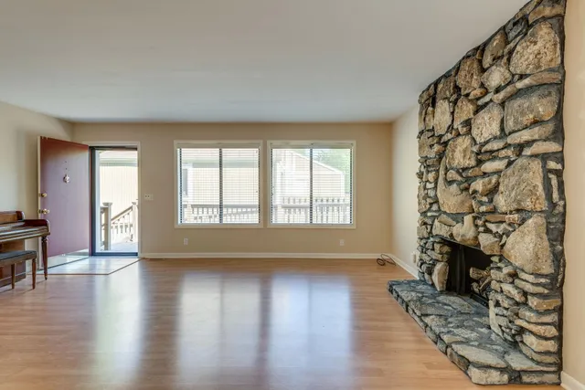 a view of a house with a yard and sitting area