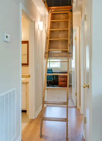 a view of a hallway with wooden floor and entryway
