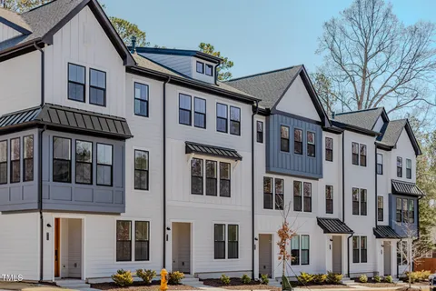 a front view of a residential apartment building with a yard