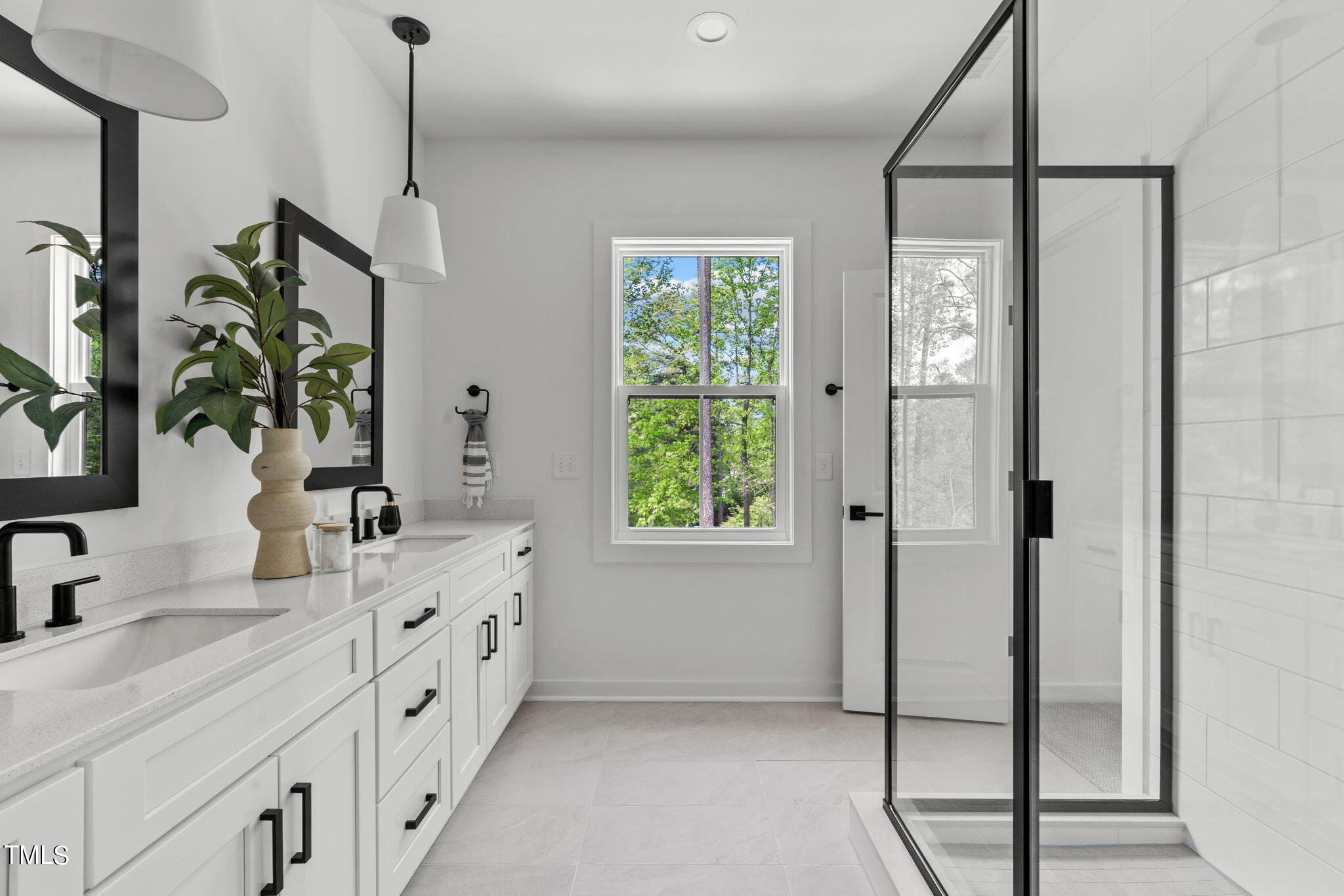 6402 Tanner Oak Lane Raleigh, NC 27613 - Photo 19 of 50 a spacious bathroom with a double vanity sink a mirror and a shower