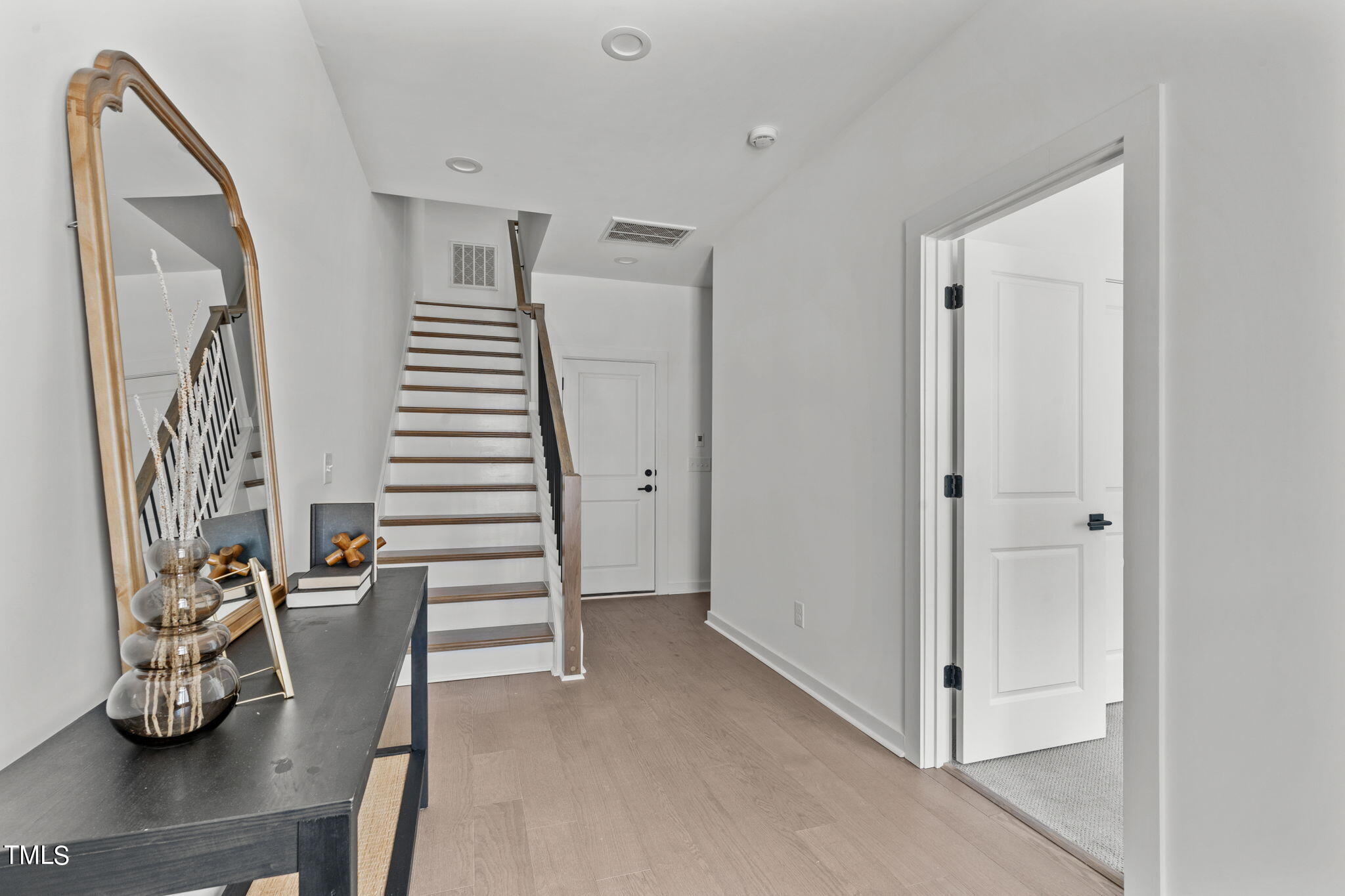 6402 Tanner Oak Lane Raleigh, NC 27613 - Photo 24 of 50 a view of entryway with stairs and wooden floor