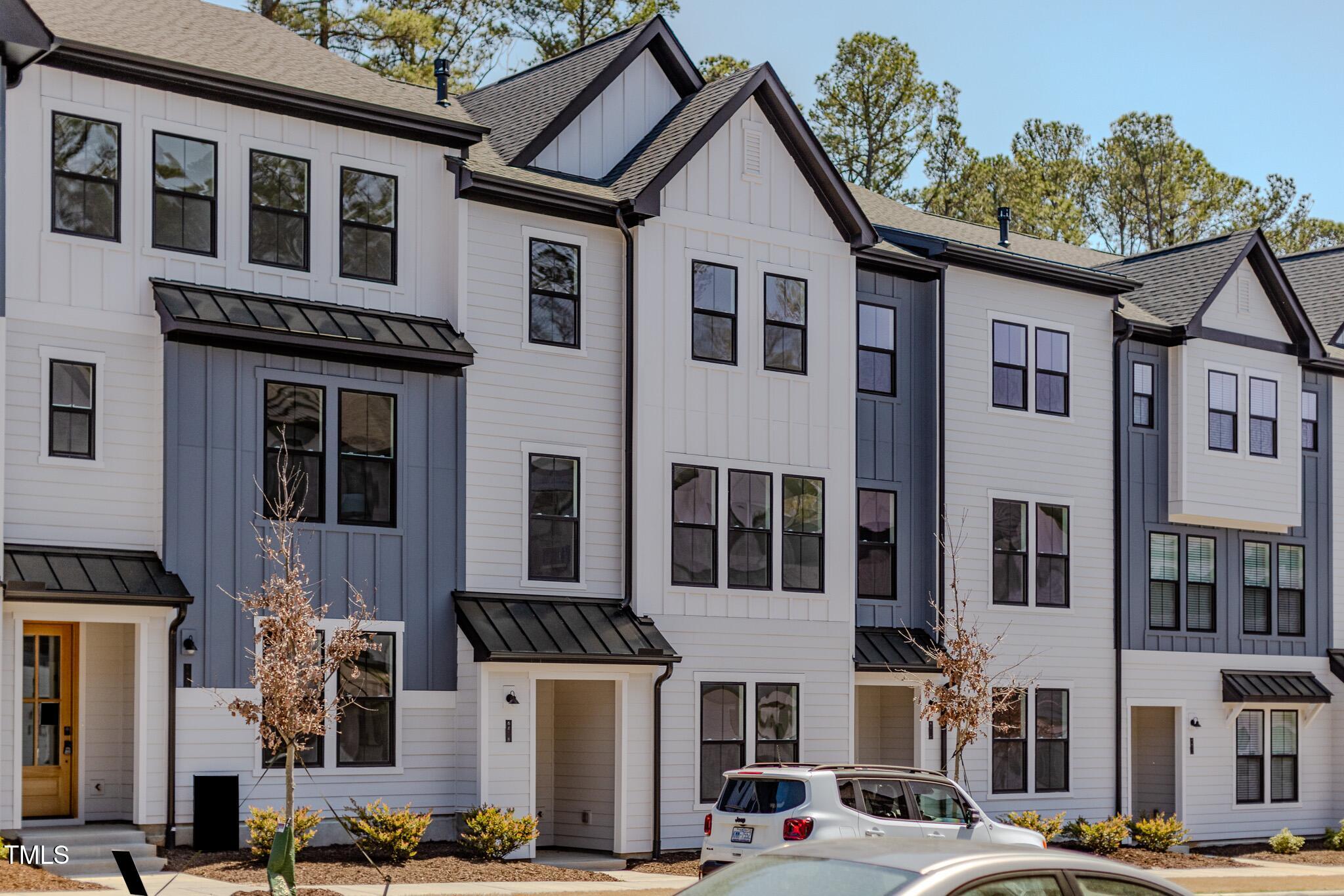 6402 Tanner Oak Lane Raleigh, NC 27613 - Photo 33 of 50 a view of a white house with large windows