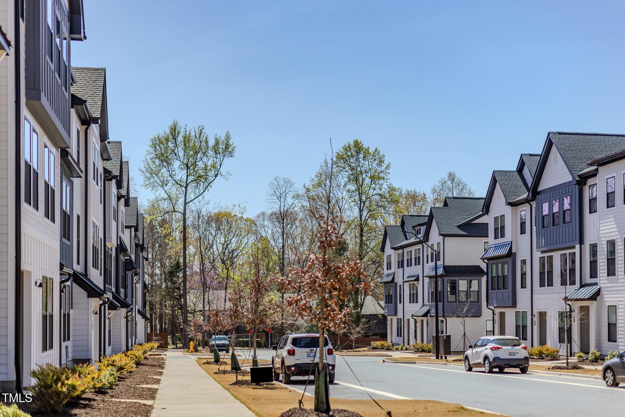 6402 Tanner Oak Lane Raleigh, NC 27613 - Photo 34 of 50 a city street lined with buildings and cars