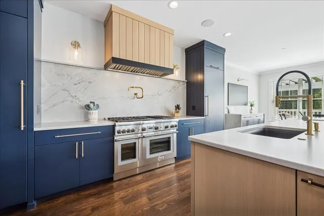 a kitchen with stainless steel appliances granite countertop a stove and a sink
