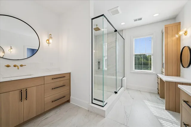 a spacious bathroom with a mirror a sink and a mirror