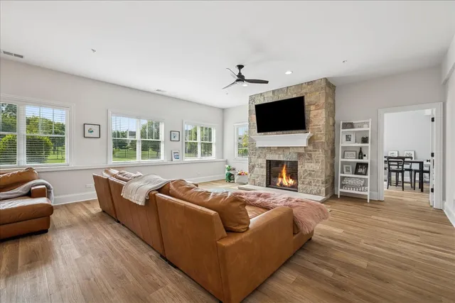 a living room with fireplace furniture and a flat screen tv