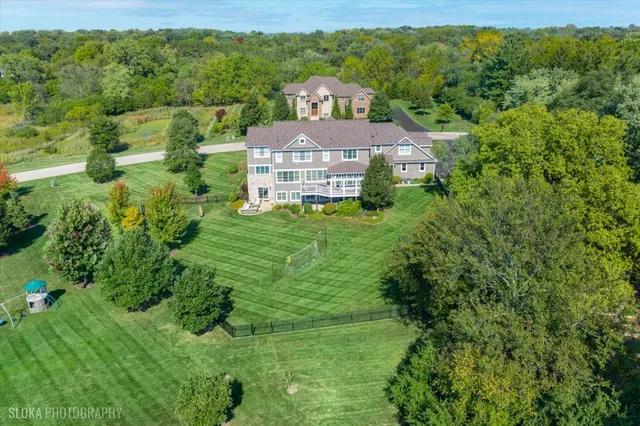 an aerial view of a house with a yard