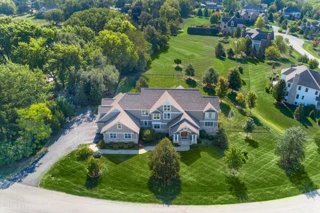 an aerial view of a house with garden space and street view