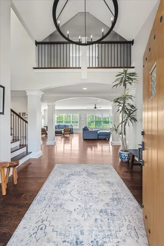 a view of entryway livingroom and hall with wooden floor