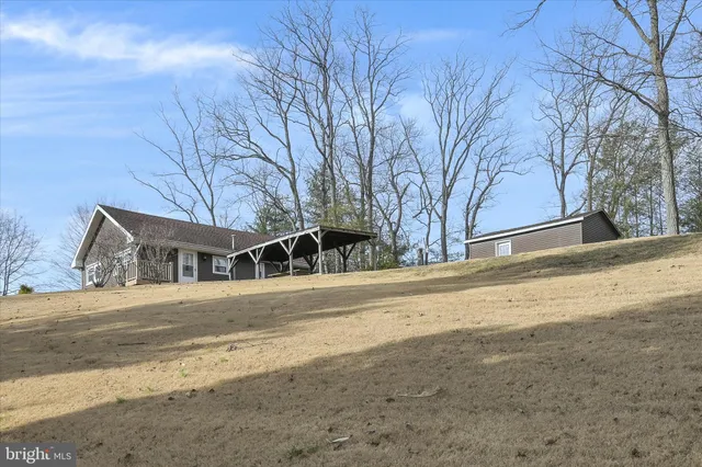 a front view of house with yard and trees