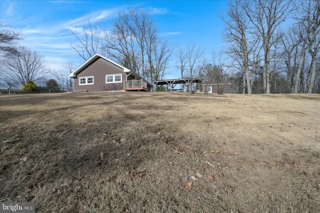 a front view of a house with a yard and covered with snow