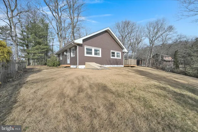 a front view of a house with a yard covered in snow