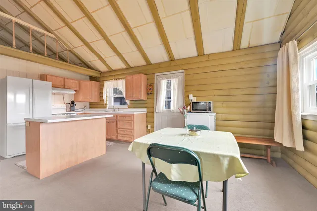 a room with stainless steel appliances kitchen island granite countertop furniture and a kitchen view