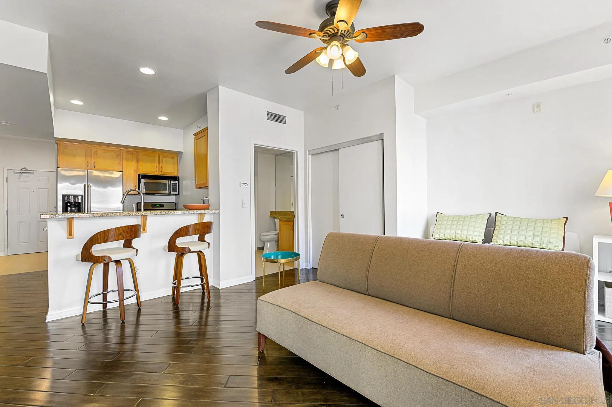 450 J Street, Unit 4121 San Diego, CA 92101 - Photo 11 of 22 a living room with furniture wooden floor and a kitchen