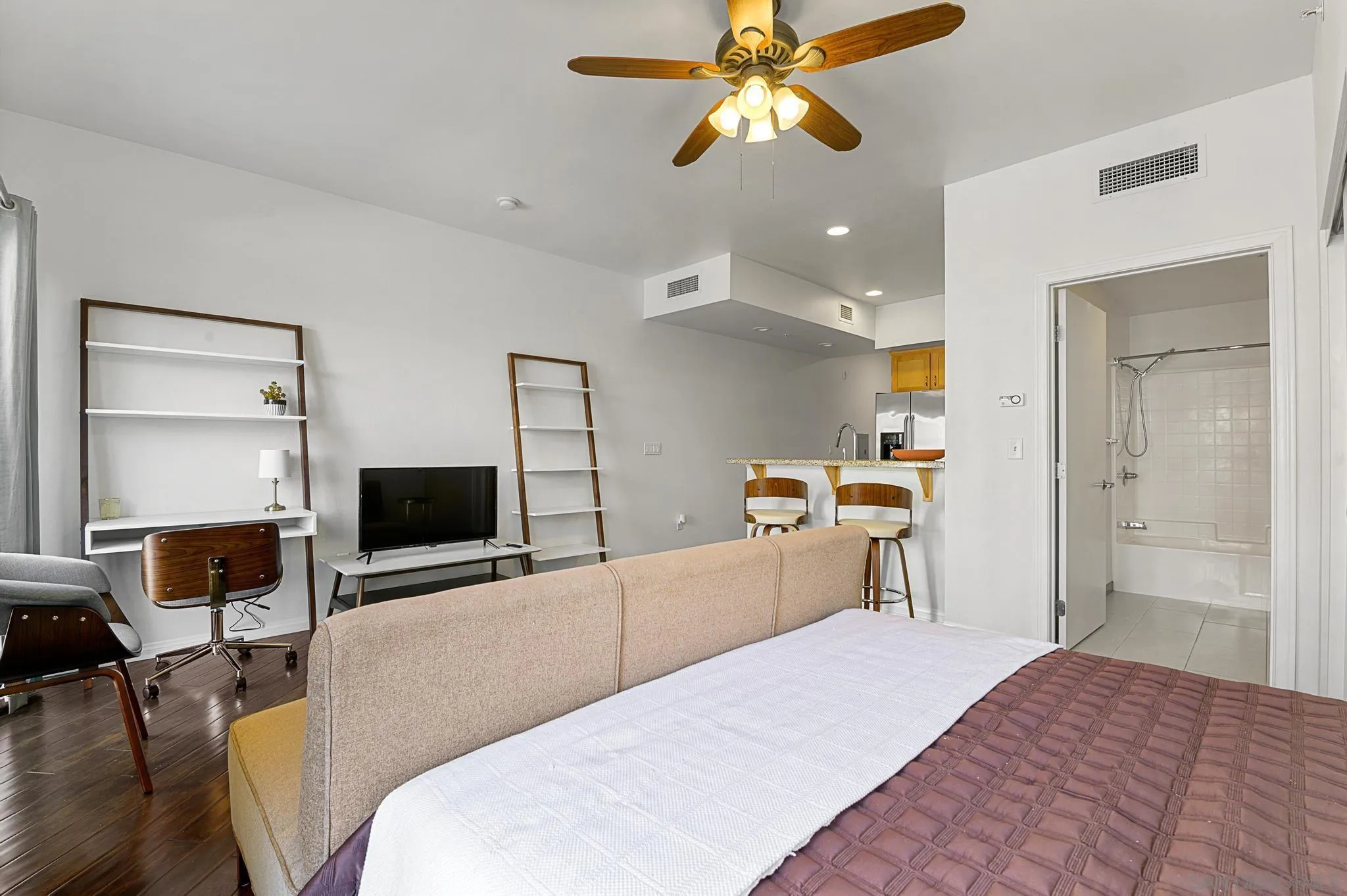 450 J Street, Unit 4121 San Diego, CA 92101 - Photo 12 of 22 a bedroom with a bed and a flat screen tv